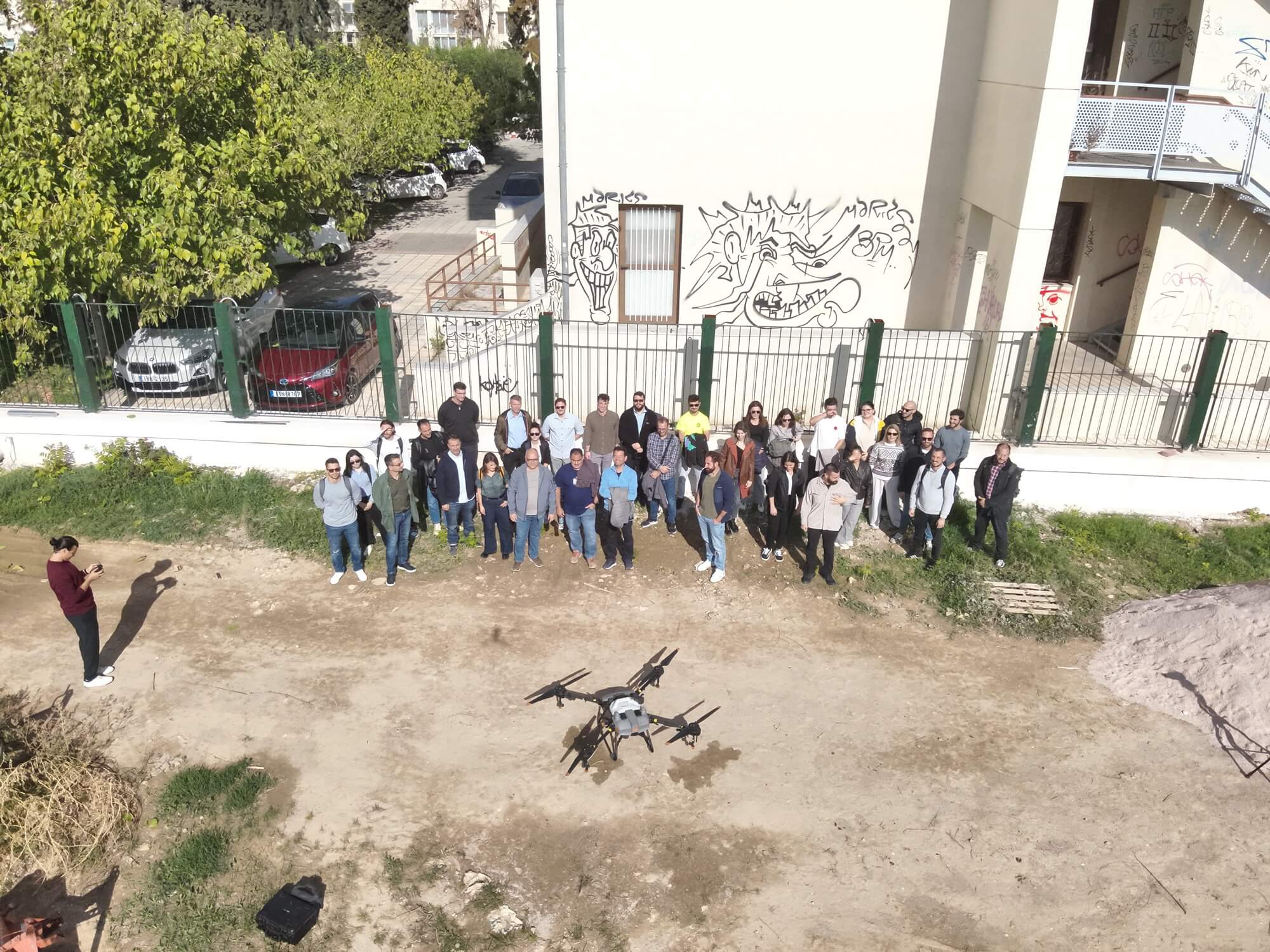 Aerial group photo of all event attendees with the drone hovering