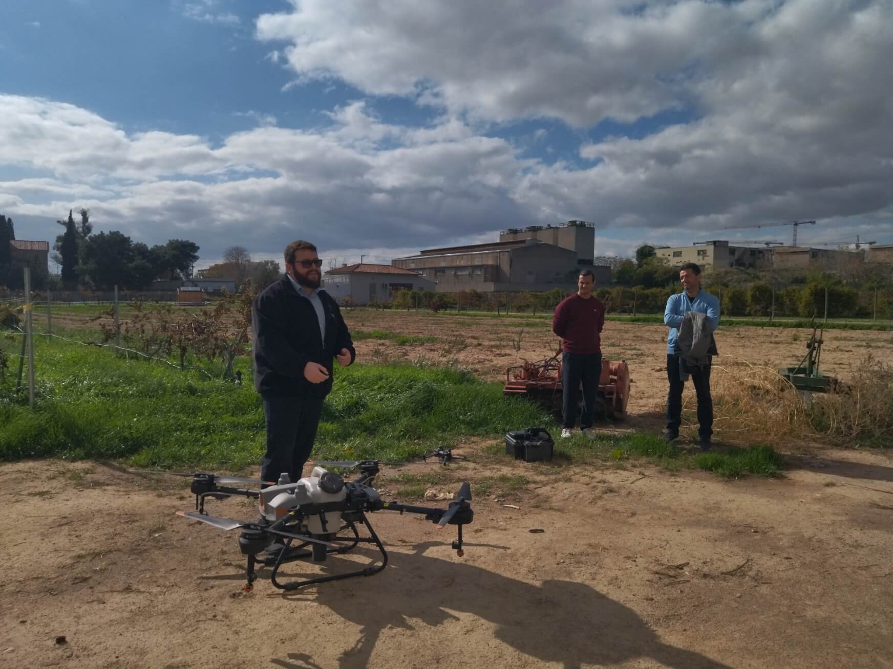 Spraying drone on the ground in the vineyard, wide view