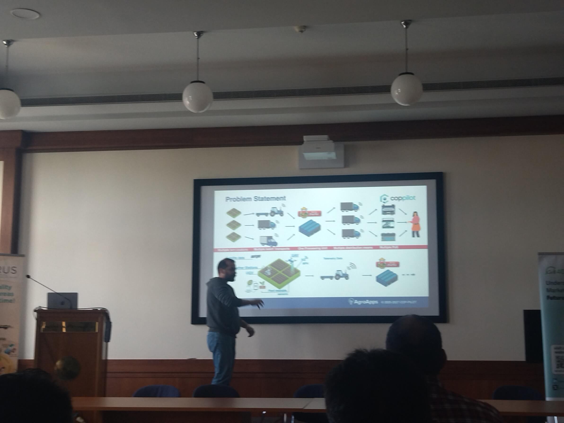 Presenter discussing the CapPilot problem statement slide